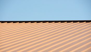 Copper,metal,roof,against,a,blue,sky.